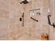 Shower with travertine tile, a pebble floor, and built-in storage niche at 5402 E Mckellips Rd # 237, Mesa, AZ 85215