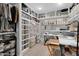 Organized walk-in closet with ample shelving, storage bins, and a crafting work space at 5402 E Mckellips Rd # 237, Mesa, AZ 85215