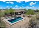 Aerial view of the pool with desert landscape, showcasing the outdoor living space at 5832 E Bent Tree Dr, Scottsdale, AZ 85266