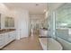 Bright bathroom featuring a soaking tub, walk-in shower, and dual vanity at 5832 E Bent Tree Dr, Scottsdale, AZ 85266