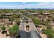 View of the gated entrance to a desert community, with lush landscaping and mountain views at 5832 E Bent Tree Dr, Scottsdale, AZ 85266