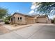 Exterior view of the stucco home with a three-car garage and desert landscaping at 5832 E Bent Tree Dr, Scottsdale, AZ 85266