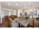 Open concept living room with hardwood floors flowing into a white kitchen with stainless steel appliances at 5832 E Bent Tree Dr, Scottsdale, AZ 85266