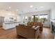 Open-concept living area with hardwood floors, kitchen island, and large windows providing ample natural light at 5832 E Bent Tree Dr, Scottsdale, AZ 85266
