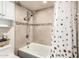 Bathroom showcasing a tiled shower with a dual showerhead and modern fixtures at 618 E Manzanita Pl, Phoenix, AZ 85020