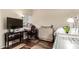 Cozy bedroom with carpet, a large window, television, and desk space at 618 E Manzanita Pl, Phoenix, AZ 85020