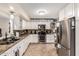 Bright kitchen featuring white cabinets, stainless steel appliances, and granite countertops at 618 E Manzanita Pl, Phoenix, AZ 85020