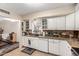 Kitchen featuring granite countertops, white cabinets, and views of the living area at 618 E Manzanita Pl, Phoenix, AZ 85020