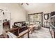 Bright living room featuring a leather sofa, large window and neutral decor with vaulted ceilings at 618 E Manzanita Pl, Phoenix, AZ 85020