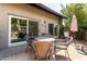 Back patio with outdoor seating, sliding glass doors, and an umbrella at 618 E Manzanita Pl, Phoenix, AZ 85020
