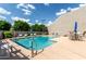 Sparkling community pool with lounge chairs and umbrellas on a sunny day at 618 E Manzanita Pl, Phoenix, AZ 85020