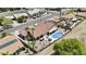 Aerial view of a home with a red tile roof, private pool, desert landscaping, and golf course views at 6249 E Camelot Dr, Mesa, AZ 85215