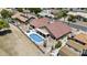 Aerial view of a home with a red tile roof, private pool, desert landscaping, and an enclosed backyard at 6249 E Camelot Dr, Mesa, AZ 85215