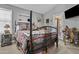 Cozy bedroom featuring a rustic wooden bed frame and unique western decor at 6249 E Camelot Dr, Mesa, AZ 85215