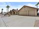 Long driveway leads to a home with desert landscaping, a tile roof, and a convenient two-car garage at 6249 E Camelot Dr, Mesa, AZ 85215