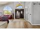 Inviting entryway featuring double doors, a chandelier, arched windows, and seamlessly connected living spaces at 6249 E Camelot Dr, Mesa, AZ 85215