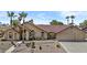Charming single-story home featuring a tile roof, desert landscaping, and a welcoming front entrance at 6249 E Camelot Dr, Mesa, AZ 85215