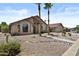 Beautiful single-story home with desert landscaping, tiled roof, and a charming front entryway at 6249 E Camelot Dr, Mesa, AZ 85215