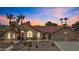 Beautiful single-Gathering home featuring lush landscaping and a well-manicured front yard at 6249 E Camelot Dr, Mesa, AZ 85215