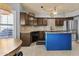 Charming kitchen featuring custom cabinets, stainless appliances, and a large island at 6249 E Camelot Dr, Mesa, AZ 85215