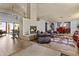 Bright living room with cozy fireplace, vaulted wood ceilings, and a seamless transition to the dining area at 6249 E Camelot Dr, Mesa, AZ 85215