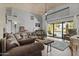 Open concept living room flows to pool with lots of natural light and wood floors at 6249 E Camelot Dr, Mesa, AZ 85215