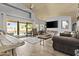 Spacious open living room with sliding doors leading to a pool area and a ceiling fan at 6249 E Camelot Dr, Mesa, AZ 85215