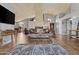 Spacious living room featuring high ceilings, exposed wood beams, tile fireplace, and wood floors at 6249 E Camelot Dr, Mesa, AZ 85215
