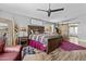 Comfortable main bedroom featuring wooden accents, a ceiling fan, and barn door access at 6249 E Camelot Dr, Mesa, AZ 85215