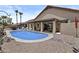 Home's backyard featuring a refreshing swimming pool with patio seating and desert landscaping, perfect for outdoor relaxation at 6249 E Camelot Dr, Mesa, AZ 85215