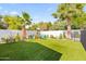 Lush backyard featuring a charming playset, well-maintained artificial grass, and mature trees for Gathering enjoyment at 6721 N 14Th Pl, Phoenix, AZ 85014