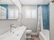 Bright bathroom features a modern vanity, blue tiled walls, and a tub with shower at 6721 N 14Th Pl, Phoenix, AZ 85014