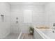 A luxurious tub and shower combination with marble-look tiling and wood-look floors at 6721 N 14Th Pl, Phoenix, AZ 85014