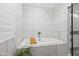 The soaking tub has tiled walls, a marble top, and a decorative plant at 6721 N 14Th Pl, Phoenix, AZ 85014