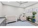 Cozy Bedroom with a white crib, accent chair, and playful decor at 6721 N 14Th Pl, Phoenix, AZ 85014