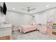A bedroom offers wood-look floors, light pink accents, and a decorative ceiling fan at 6721 N 14Th Pl, Phoenix, AZ 85014