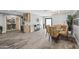 Open-concept dining room with modern light fixture, hardwood floors, and easy access to pantry at 6721 N 14Th Pl, Phoenix, AZ 85014