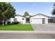 Striking single-story home with a well-manicured lawn, a two-car garage, and desert landscaping at 6721 N 14Th Pl, Phoenix, AZ 85014