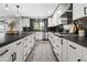 Modern kitchen with white cabinets, dark countertops, subway tile backsplash, and stainless steel appliances at 6721 N 14Th Pl, Phoenix, AZ 85014