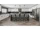 Well-lit kitchen with white cabinets, black backsplash, a large island with seating, and modern pendant lighting at 6721 N 14Th Pl, Phoenix, AZ 85014
