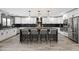 Beautiful kitchen showcasing white cabinets, black tile backsplash, and an island with bar stool seating at 6721 N 14Th Pl, Phoenix, AZ 85014
