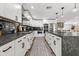 Modern kitchen with white cabinets, black backsplash, stainless steel appliances, and a spacious center island at 6721 N 14Th Pl, Phoenix, AZ 85014