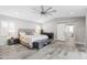 View of the main bedroom showcasing its ensuite bathroom with a sliding barn door and wood-look tile floors at 6721 N 14Th Pl, Phoenix, AZ 85014