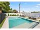Sparkling pool with water feature, lounge chairs, and an umbrella-covered dining area, creating a serene backyard oasis at 6721 N 14Th Pl, Phoenix, AZ 85014