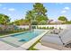 Inviting backyard pool with lounge chairs, dining set, lush landscaping, and a play area at 6721 N 14Th Pl, Phoenix, AZ 85014