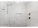 A modern shower features decorative marble walls, tiled floors, and dual shower heads at 6721 N 14Th Pl, Phoenix, AZ 85014
