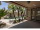 Covered patio area with view of palm trees and a freeform pool at 6917 E Night Glow Cir, Scottsdale, AZ 85266