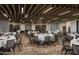 Large banquet hall featuring round tables, grey chairs, wine storage, and an elegant wooden ceiling at 6917 E Night Glow Cir, Scottsdale, AZ 85266