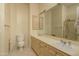 Bathroom featuring dual sinks, neutral cabinets, and a large mirror at 6917 E Night Glow Cir, Scottsdale, AZ 85266
