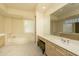 Bright primary bathroom with a large soaking tub, plenty of cabinets and a vanity at 6917 E Night Glow Cir, Scottsdale, AZ 85266